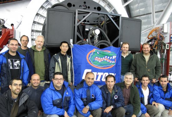 Parte del equipo que participó en la primera instalación y ajuste de CanariCam en el Gran Telescopio CANARIAS. En la foto, el instrumento se encuentra instalado en el foco Nasmyth, justo por encima de la bandera de “Gators” que el personal procedente de la Universidad de Florida colocó junto a la cámara.